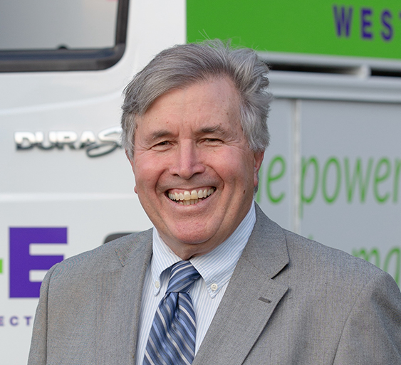 Headshot of Fran Liptak, MLB Commissioner in blue jacket in front of utility truck